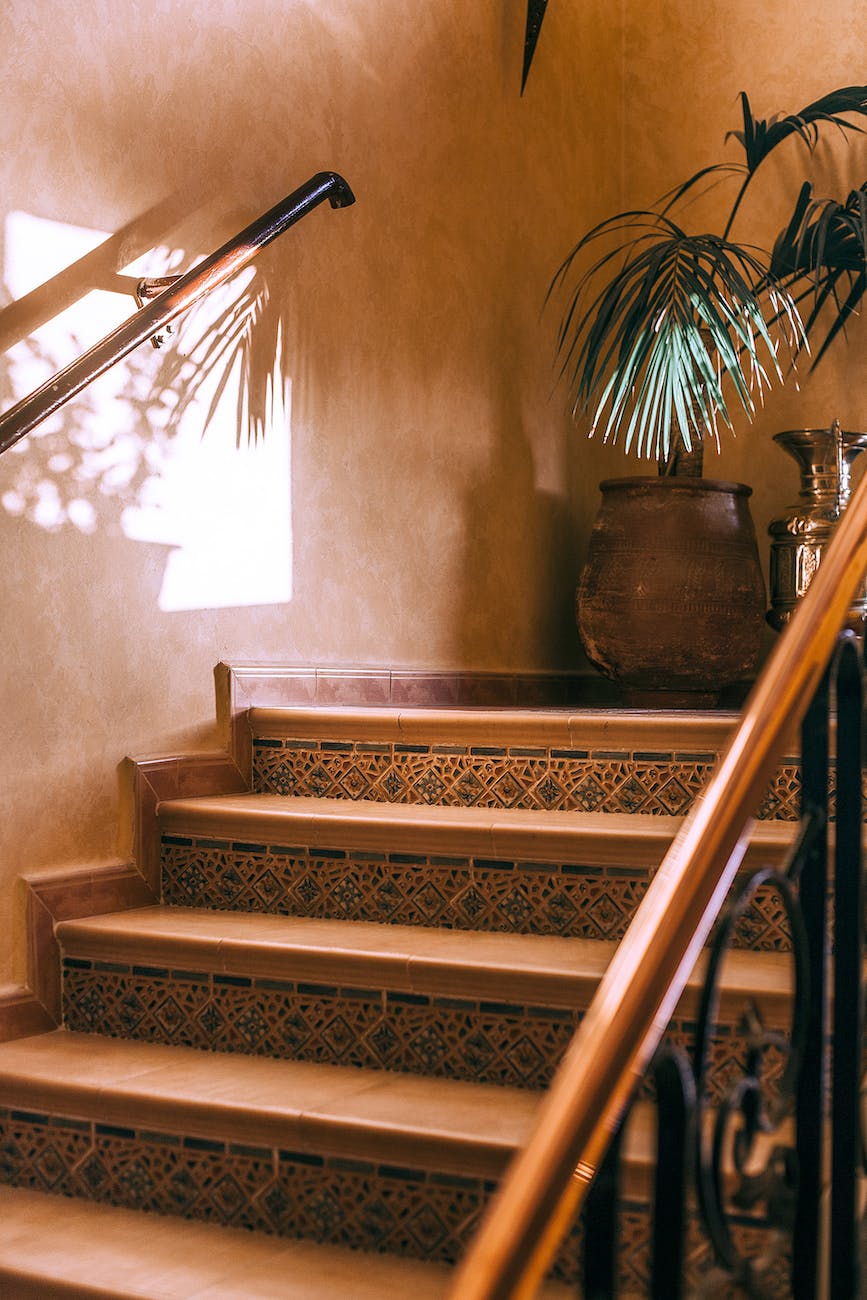 interior with stone staircase with ornament and reflection of palm on wall- Apartment Decorating Ideas for Renters